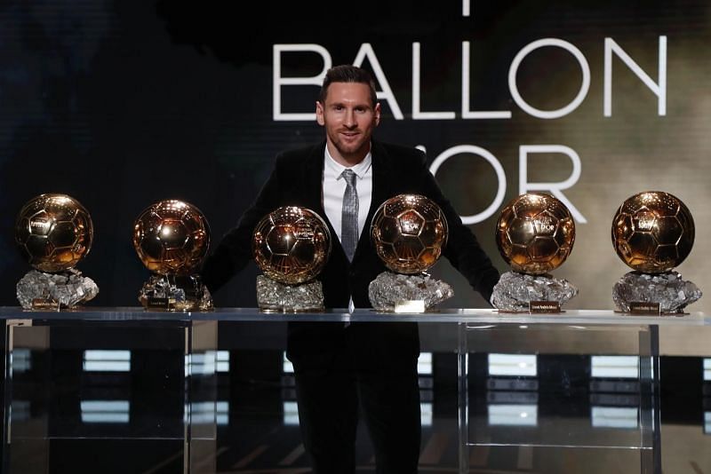 Lionel Messi posing with his six Ballon d'Or awards